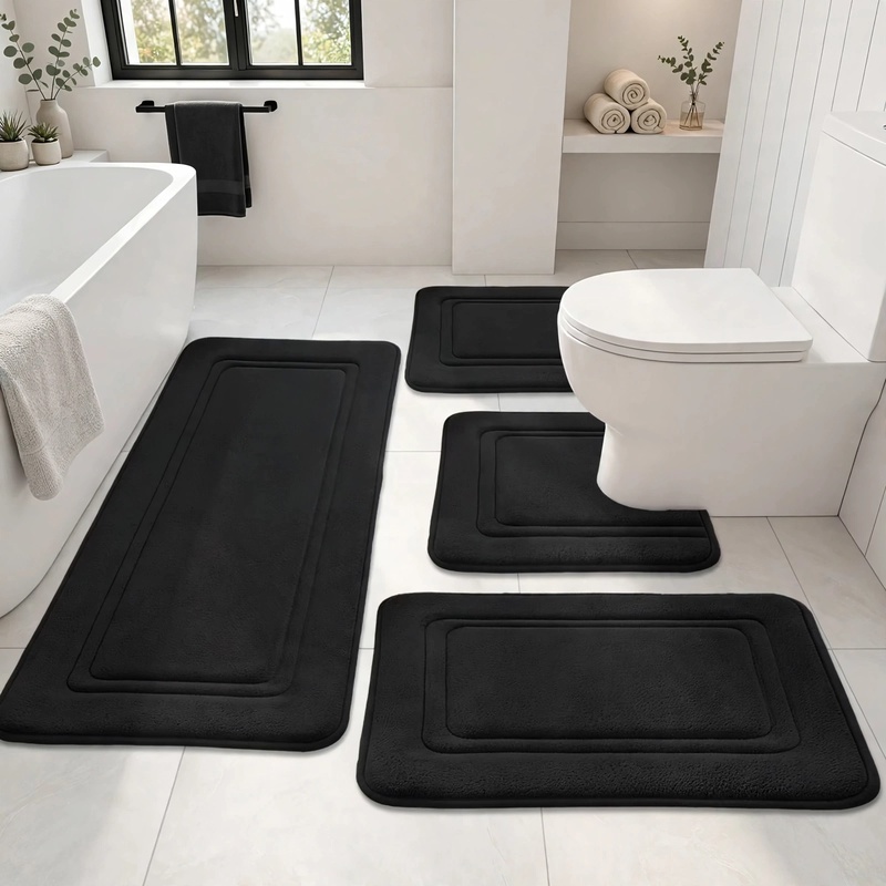 4Ps Advanced Bathroom Mat - Quick-Drying Memory Foam, Machine Washable, Thick Non-Slip Carpet, Suitable for Shower Rooms, Kitchens, And Laundry Rooms - Soft And Comfortable Home Decor 4 A clean front-view photograph of the 4-piece black bathroom mat set neatly arranged on a white tile floor next to a bathtub and toilet.