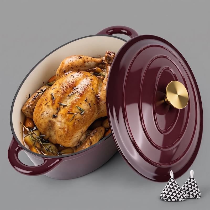 exclusive 4.5QT Enameled Dutch Oven Pot With Lid, Cast Iron Dutch Oven With Dual Handles For Bread Baking, Cooking, Non-stick Enamel Coated Cookware 5 A high-angle, 3/4 view of a rich, glossy burgundy oval Enameled Dutch Oven Pot With Lid. The pot is open, revealing a whole golden-brown roasted chicken surrounded by roasted potatoes and rosemary. The matching burgundy lid, featuring a gold-colored knob, is placed next to the pot. In the lower-right corner, there are two small, pyramid-shaped oven mitts with a black-and-white geometric pattern. The entire setup is on a solid grey background.