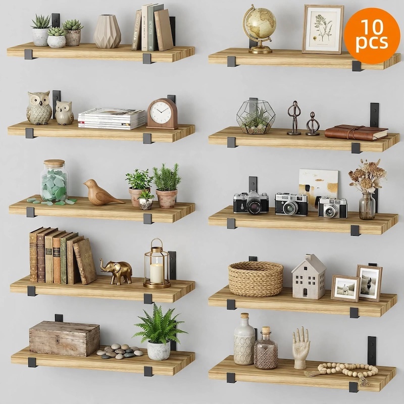 Front view grid of 10 wooden floating shelves for wall styled neatly with books, cameras, plants, and decorative trinkets.