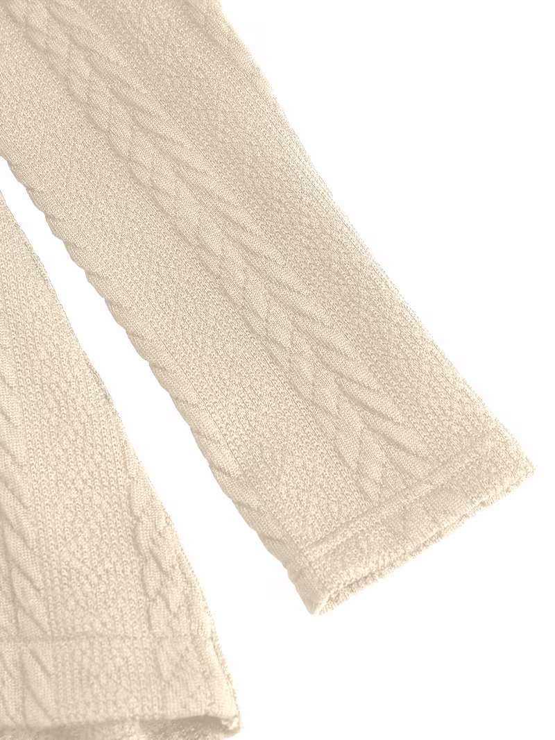 useful Sophisticated Decorative Buttoned Long Sleeve Top | Modern High Neck Knit for Business Casual 13 A detailed view of the ribbed cuff and cable weave sleeve of a beige decorative buttoned top.
