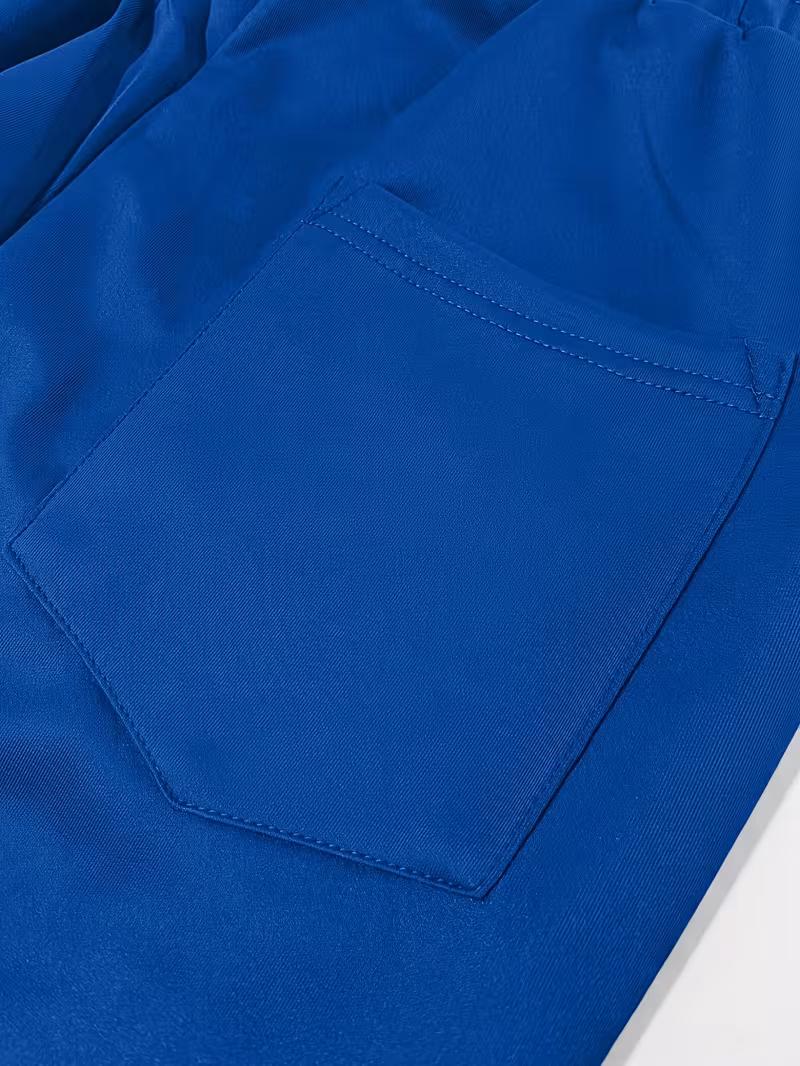 Men'S Color-Blocked Casual Pants Feature a Stylish Design with Comfortable And Structured Fabric. The Drawstring Waist Fits The Body Well, Making It Trendy And Eye-Catching. with a Loose Straight Cut 12 Macro shot of the functional rear patch pocket on the blue panel of the pants.