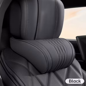 A close-up of a premium black car headrest featuring the Luxury Napa Neck Pillow. The pillow is made of high-quality perforated Napa leather with elegant pleated stitching, designed to provide deep-tissue cervical support in a luxury vehicle interior.