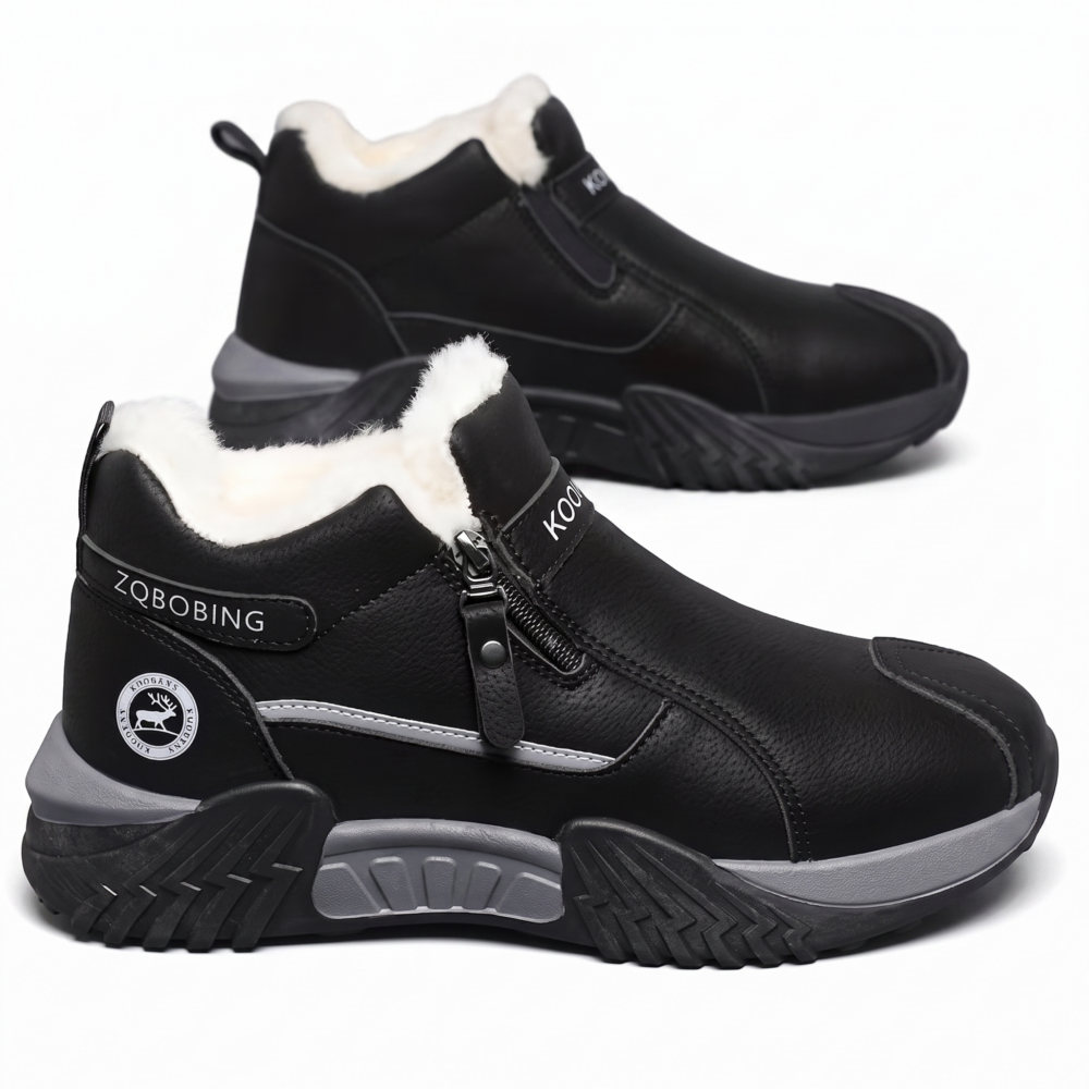 A high-quality studio shot displaying a primary black color Insulated Fleece-Lined Snow Boot in the foreground showing its complete side profile, with a secondary matching boot positioned slightly behind for depth. The design highlights the side metal zipper, grey midsole pods, and a circular deer emblem on a white background.