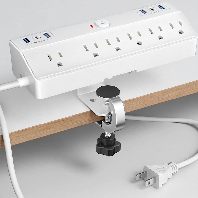 Studio front-angle view of the 5+1 Clips white Desk Clamp Power Strip With USB highlighting its mounting clamp and outlets.