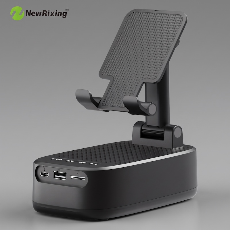 A high-end studio product shot of the black NewRixing Wireless Speaker with Phone Holder, showcasing the front panel with USB-C, USB-A, and microSD card slots. A white matte surface.