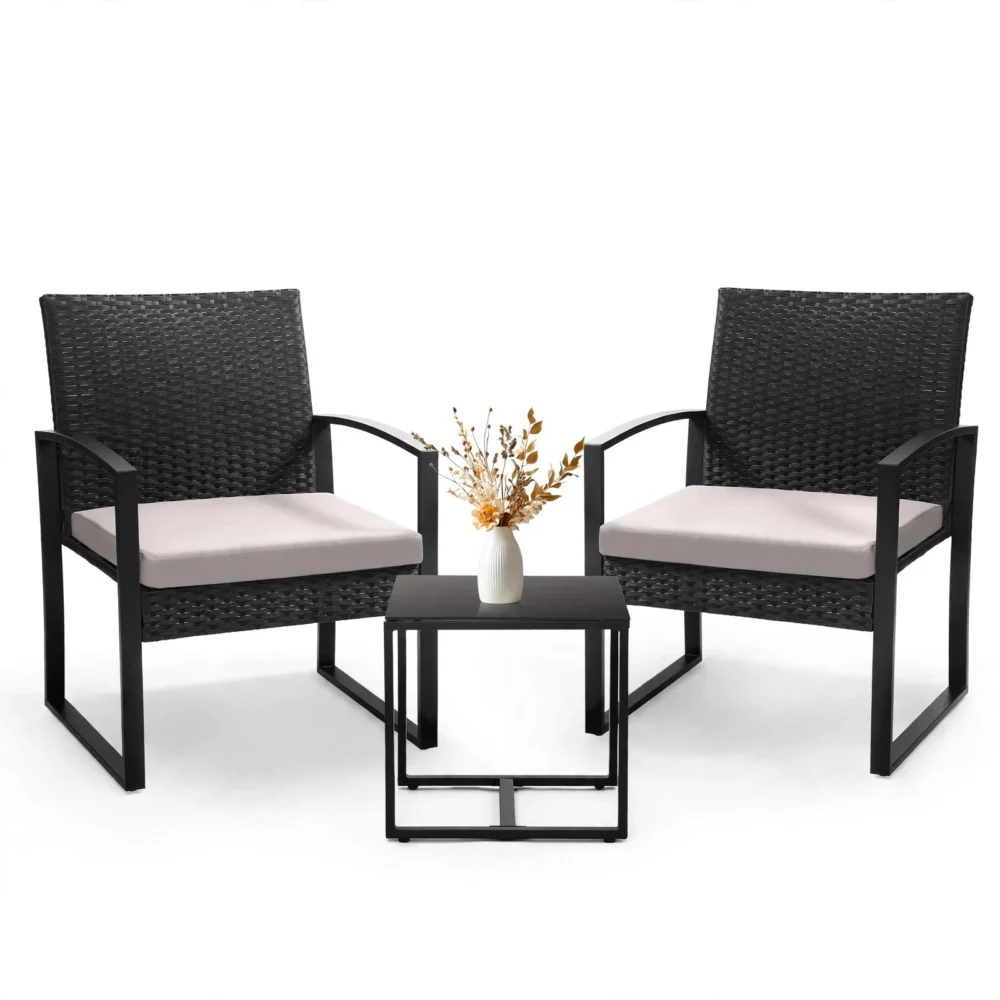 A studio front view of a patio set featuring front view black rattan gray 2 Chairs And 1 Safety Glass Top Table with a small vase.