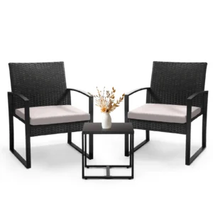 A studio front view of a patio set featuring front view black rattan gray 2 Chairs And 1 Safety Glass Top Table with a small vase.