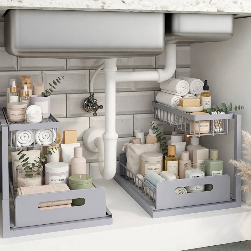 reliable Metal Under Sink Organizers, Pull Out Under Sink Storage Shelves with Sliding Drawer for Kitchen, Bathroom (1pack/2pack) 13 Dual gray 2pack Metal Under Sink Organizers utilized in a luxury bathroom vanity to hold rolled towels, skincare bottles, and bath salts.