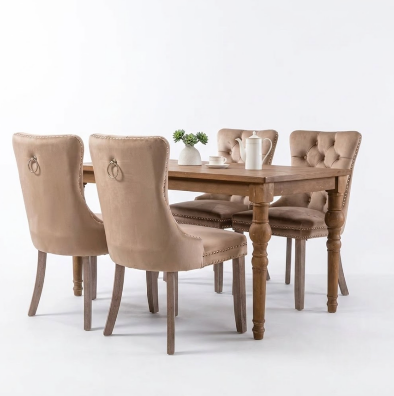 Set of 4 Upholstered Dining Chairs, Velvet Chairs with Button Tufting And Sturdy Wooden Legs, Contemporary Fabric Side Chairs for Dining Areas, Kitchens, Restaurants, And Hotels 11 A kahaki color Set of 4 Upholstered Dining Chairs arranged around a traditional wooden dining table featuring decorative backrest pull rings.