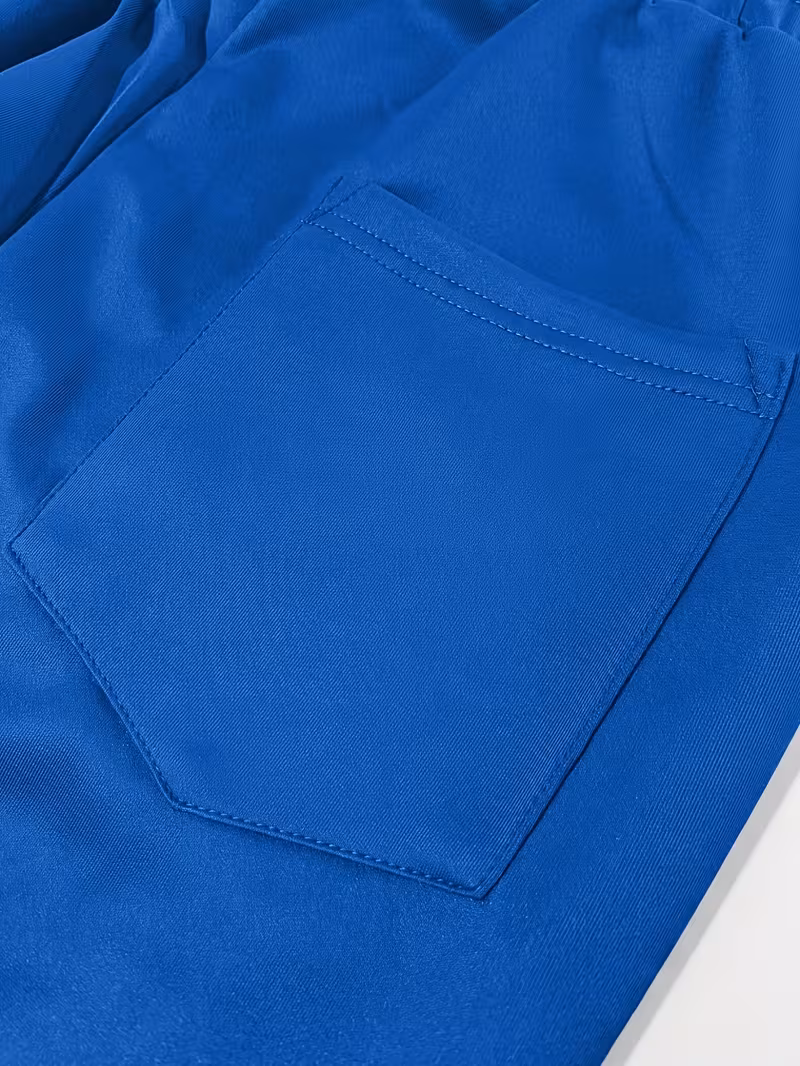 Men'S Color-Blocked Casual Pants Feature a Stylish Design with Comfortable And Structured Fabric. The Drawstring Waist Fits The Body Well, Making It Trendy And Eye-Catching. with a Loose Straight Cut 43 Close-up shot of a functional rear patch pocket stitched onto the light blue panel of casual pants.