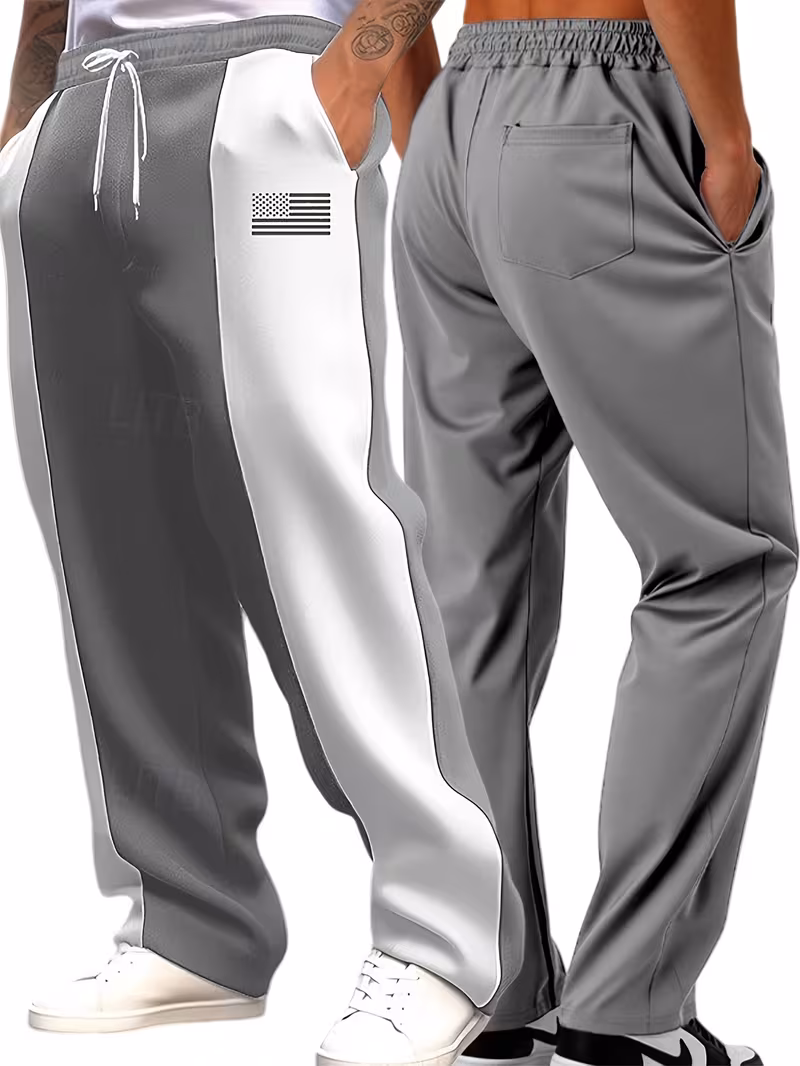 Men'S Color-Blocked Casual Pants Feature a Stylish Design with Comfortable And Structured Fabric. The Drawstring Waist Fits The Body Well, Making It Trendy And Eye-Catching. with a Loose Straight Cut 53 win model studio shot displaying the front three-quarter and rear fit profiles of light grey and white color-blocked casual pants.