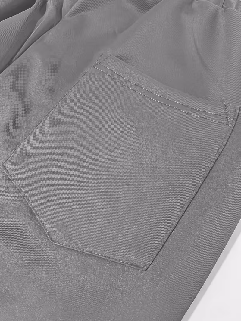Men'S Color-Blocked Casual Pants Feature a Stylish Design with Comfortable And Structured Fabric. The Drawstring Waist Fits The Body Well, Making It Trendy And Eye-Catching. with a Loose Straight Cut 49 Close-up view of a structured rear patch pocket with neat geometric double-needle stitching on grey fabric.