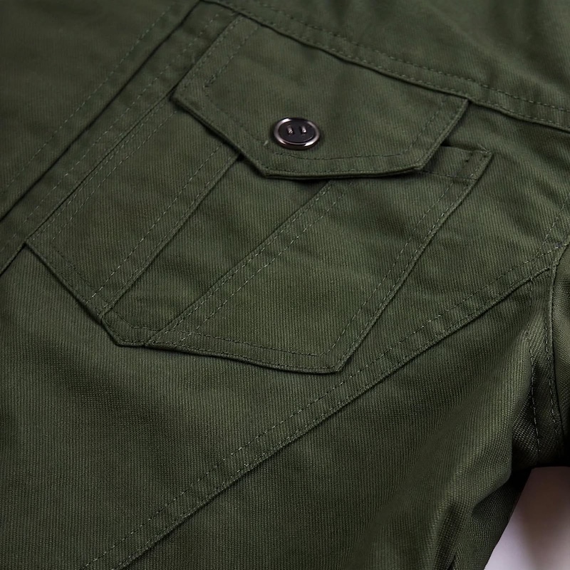 Men's Tactical Jacket Practical Men's Tactical Jacket | Multiple Pockets, Workwear Style Coat 18 Macro close-up shot of the reinforced chest pocket and stitching details on an olive green color Men's Tactical Jacket Practical.