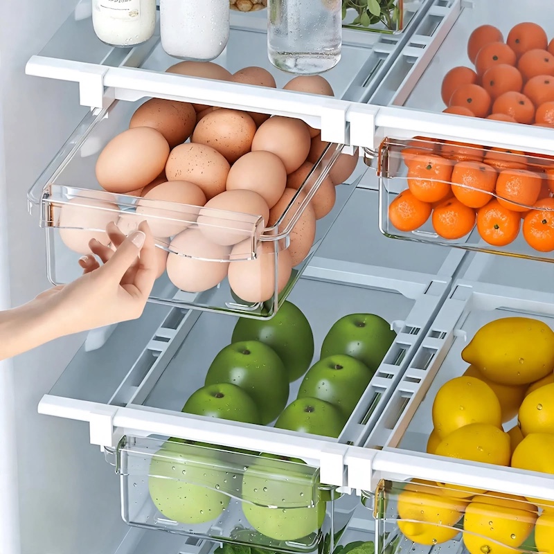 1pc Refrigerator Drawer Organizer Egg Rack, Refrigerator Drawer Storage Box Hanging Basket, Kitchen Fresh-keeping Freezer Shelf Holding Artifact, Suitable for Pull-out Refrigerator Drawer, Transparent Fruit and Vegetable Storage Box 3 A hand sliding out the clear bin of a 1pc Refrigerator Drawer Organizer Egg Rack filled with fresh brown eggs.