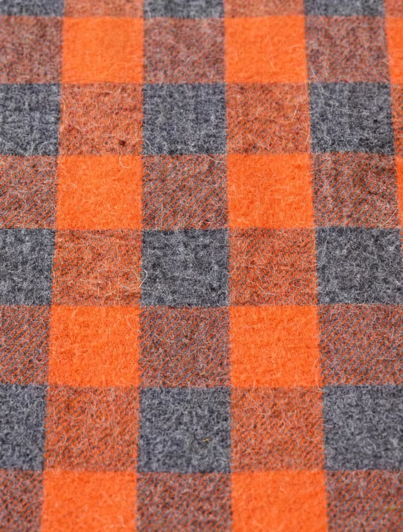 2pcs Men's New York Fashion Trendy Plaid Shirt Hoodie, Plaid Pullover Sweatshirt Flannel Hoodie 14 Close-up macro view of the soft flannel fabric of a fashion trendy plaid shirt hoodie featuring an orange and charcoal gray buffalo check pattern.