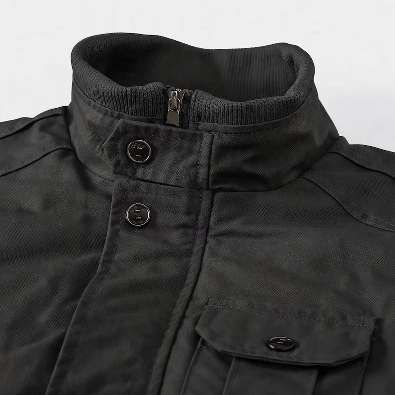 Men's Tactical Jacket Practical Men's Tactical Jacket | Multiple Pockets, Workwear Style Coat 10 Macro close-up view of the collar, buttons, and zipper hardware on a black color Men's Tactical Jacket Practical.