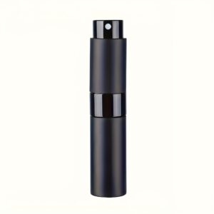 A professional product photograph featuring a single (1 pc Pack) 0.27oz (8ml) travel perfume spray bottle. The atomizer has a sophisticated matte black finish and a precise fine-mist nozzle, positioned upright on a textured, neutral beige surface. A naturally manicured left hand with glossy peach-pink nails is gently reaching towards and holding the base of the sleek, black bottle. Diffused daylight from a large, out-of-focus window with potted greenery in the background creates a clean, elegant, and inviting craft scene. The focus is entirely on the integrated symmetry node, visual state purity, and high-fidelity material, highlighting the practical yet luxury nature of the perfume atomizer and its integrated comfort logic. The background curtains and plant are softly blurred. All details are preserved and rendered with sharp clarity.