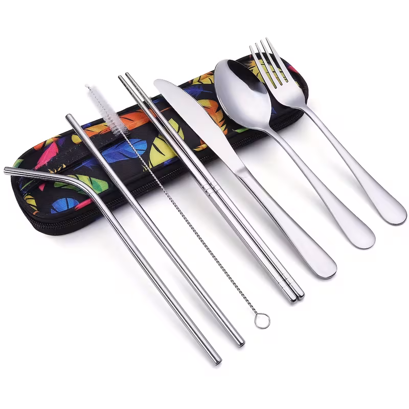reliable Unyielding Travel Utensils Reusable Silverware Set: Professional-Grade Stainless Steel Cutlery in a Weatherproof Armor Case 21 featuring the feather style sliver color Travel Utensils Reusable Silverware Set. Eight pieces of highly detailed, feather-shaped silver cutlery—including various forks, spoons, and a knife—are organized fanned out on a textured wooden table next to an open, gray fabric zippered carrying pouch, illustrating zero bulk lag for dynamic activity and generic group synergy guide compatibility.