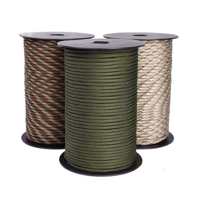 The Ultimate 164ft Roll of 9-Strand Rope 4mm: Heavy-Duty Utility Cord for Tents & Tarps 1 Three spools of premium utility cord, including solid olive green, woodland camouflage, and desert tan patterns, showcasing the variety available in this Roll of 9-Strand Rope 4mm.