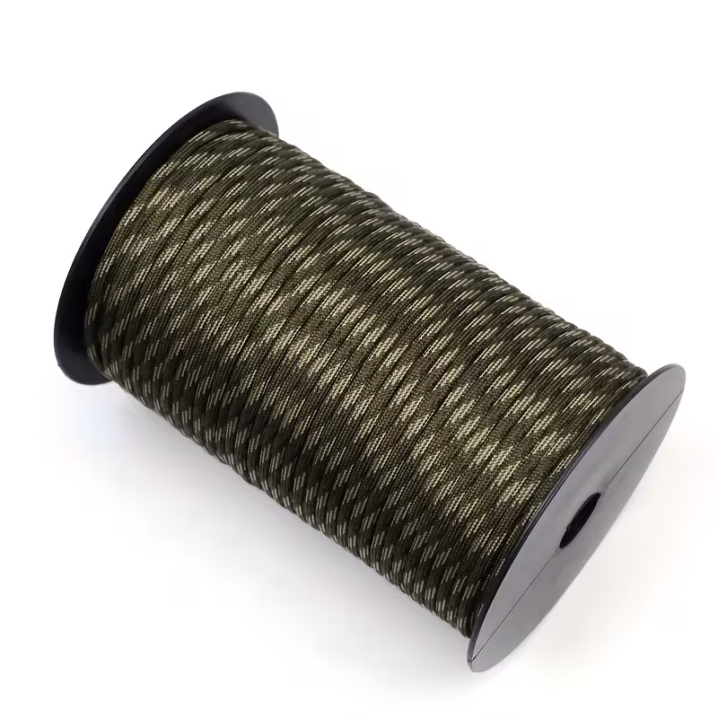 The Ultimate 164ft Roll of 9-Strand Rope 4mm: Heavy-Duty Utility Cord for Tents & Tarps 15 An elevated view of a Roll of 9-Strand Rope 4Mm featuring a woodland camouflage pattern, neatly wound on a black plastic spool against a white background.
