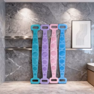 Four long-handle silicone back scrubbers in teal, purple, pink, and blue leaning against a marble bathroom wall, showcasing the textured exfoliating surfaces and ergonomic grip handles of the random color Pack Body Sponge Brush.