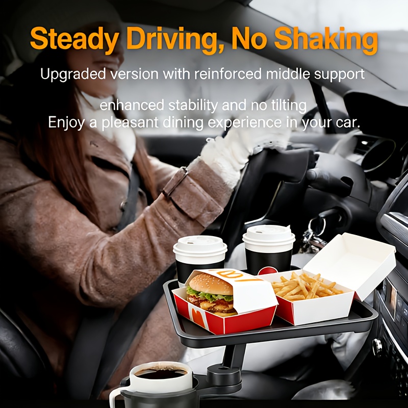 Operational Infrastructure Node: Car Cup Holder Expansion Tray with 40lb Load Capacity and 360° Rotating Mechanical Base for Superior Cabin Utility 8 A professional high-definition lifestyle photograph showcasing the upgraded Car Cup Holder Expansion Tray within a vehicle cabin. The image features a female driver in winter attire, while the foreground highlights the reinforced matte black tray system. The tray is securely staged with a burger box, an open container of fries, and two coffee cups, with a third beverage in the base holder. Overlay text emphasizes "Steady Driving, No Shaking" and a "Reinforced middle support" for enhanced stability. The focus is sharp on the tray’s structural articulation and its ability to remain level and secure during transit.