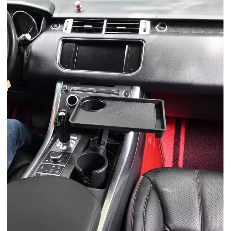Operational Infrastructure Node: Car Cup Holder Expansion Tray with 40lb Load Capacity and 360° Rotating Mechanical Base for Superior Cabin Utility 4 A professional product photograph showcasing the Car Cup Holder Expansion Tray in a matte black finish against a clean white background. The hardware features a robust base cup adapter that expands to fit most standard vehicle cup holders, an articulating swivel arm with multi-pivot points, and a large, horizontal expansion tray with a non-slip textured inlay. The composition highlights the tray's perimeter retention lip, a designated second beverage well, and a media slot for secure smartphone viewing. directional arrows demonstrate the adjustment mechanisms. The texture of the high-impact polymer is rendered with sharp, high-definition clarity.