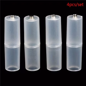 Four translucent plastic AAA to AA battery converter adapter cases standing upright against a black background.