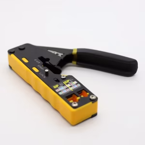 A black and yellow professional Dual-Use CAT.6 Through-Hole and standard RJ45 crimping tool lying flat on a white background. The tool features clearly marked 'CUT', 'STRIP', and 'LOCK' switches, along with two distinct crimp nests for 8P and 6P connectors, and a detailed color-coded T568A/B wiring diagram label. The long black ergonomic handle is visible.