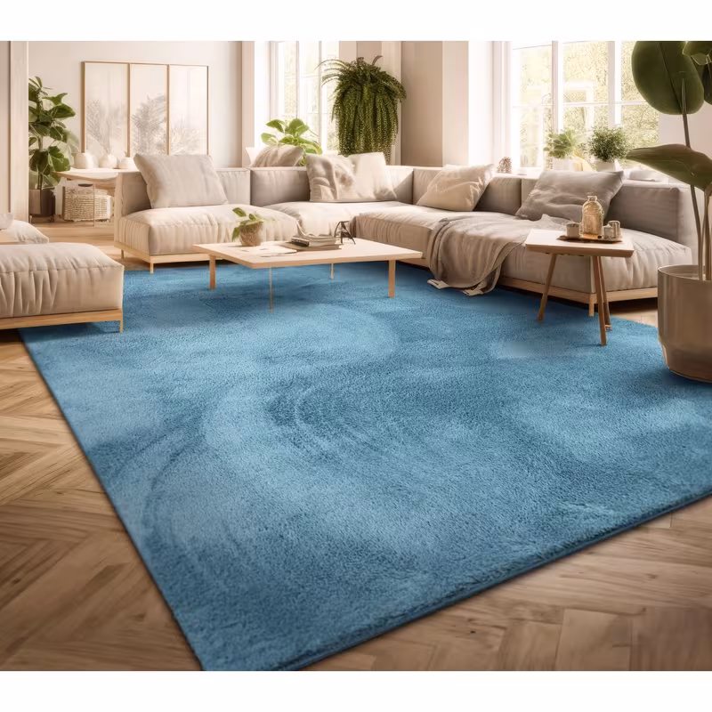 exclusive Modern Living Room Rug – Washable Short Pile Area Rug | Stain-Resistant & Non-Slip Premium Polyester 13 A large, vibrant turquoise modern living room rug spread across a light herringbone hardwood floor, centered below a neutral cream modular sectional sofa and minimalist wooden coffee tables in a bright, sunlit room filled with houseplants.