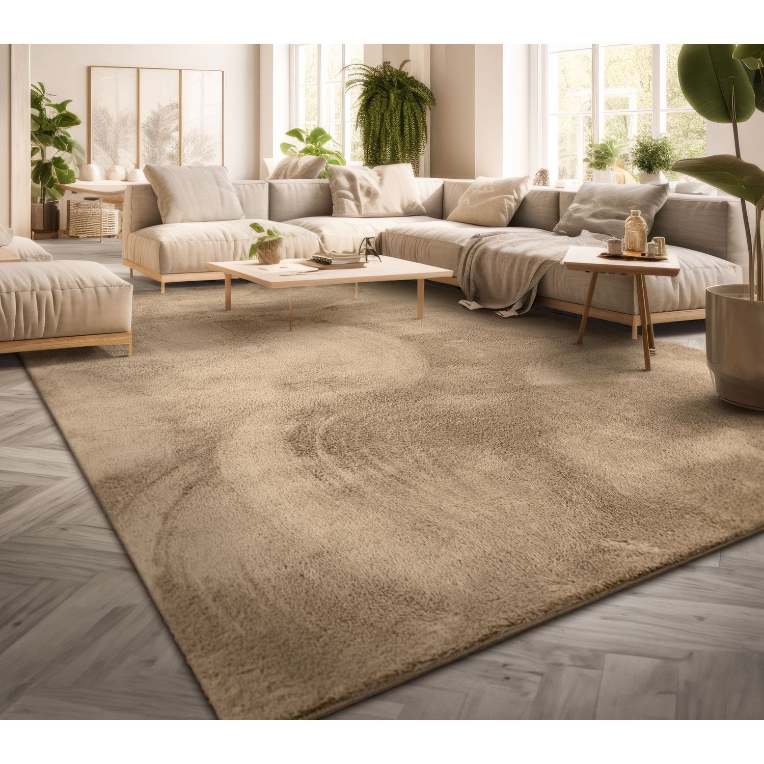 exclusive Modern Living Room Rug – Washable Short Pile Area Rug | Stain-Resistant & Non-Slip Premium Polyester 4 A large warm dark beige modern living room rug laid across a light herringbone hardwood floor beneath a contemporary cream colored sectional sofa and minimalist wooden coffee tables in a bright sunlit room filled with houseplants
