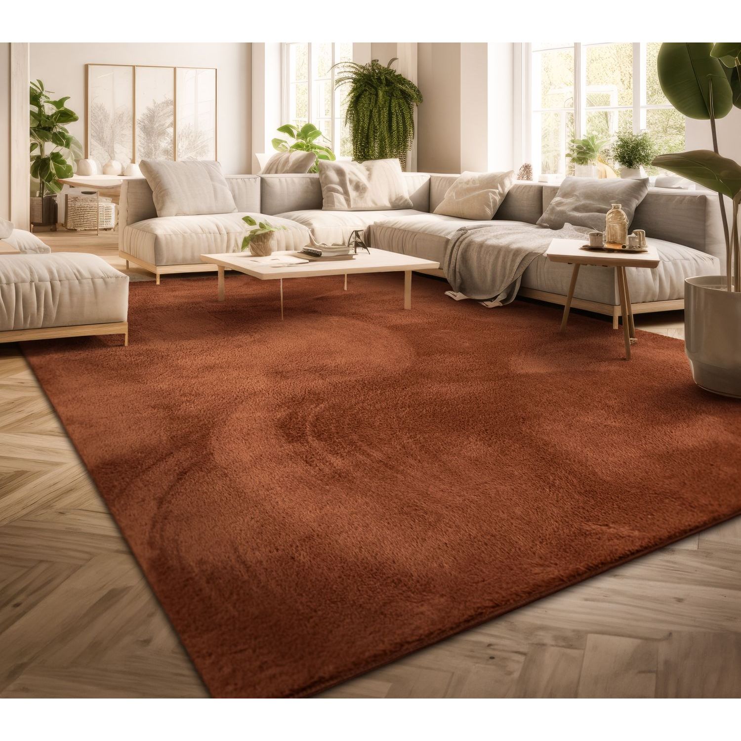 exclusive Modern Living Room Rug – Washable Short Pile Area Rug | Stain-Resistant & Non-Slip Premium Polyester 3 A large warm copper colored modern living room rug laid across a light herringbone hardwood floor beneath a contemporary cream colored sectional sofa and minimalist wooden coffee tables in a bright sunlit room filled with houseplants