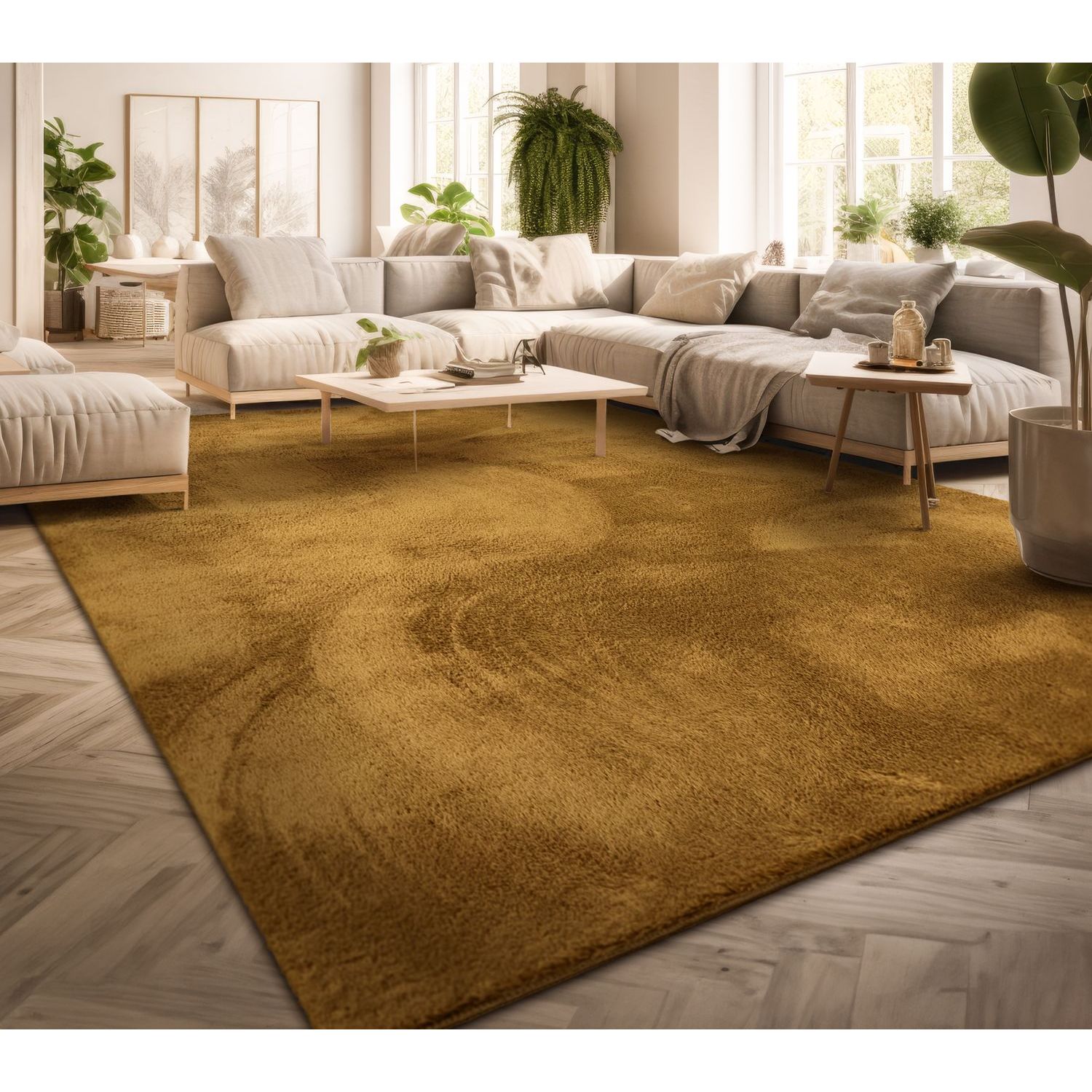 exclusive Modern Living Room Rug – Washable Short Pile Area Rug | Stain-Resistant & Non-Slip Premium Polyester 9 A large, warm mustard yellow modern living room rug laid over a light gray herringbone wood floor, supporting a minimalist cream-colored modular sectional sofa and low wooden accent tables in a bright interior filled with lush green houseplants.