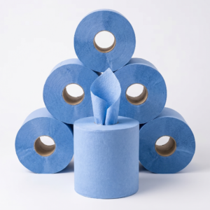 Five blue centerfeed paper towels rolls stacked in a pyramid with one roll centered in front, feeding paper upward from its core against a clean studio backdrop.
